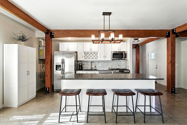 1106 Larch St Unit A, Sandpoint, ID 83864 - kitchen featuring appliances with stainless steel finishes, concrete floors, backsplash, beam ceiling, and a kitchen breakfast bar