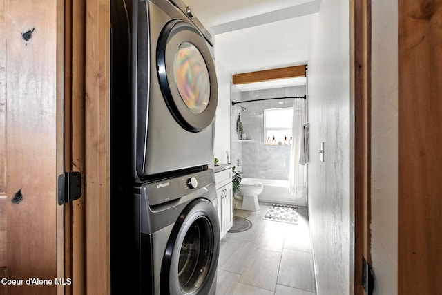 1106 Larch St Unit A, Sandpoint, ID 83864 - laundry room featuring stacked washing machine and dryer and light tile patterned floors