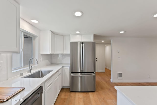 15116 E 4th Ave, Veradale, WA 99037 - kitchen with freestanding refrigerator, white cabinetry, light countertops, light wood-style floors, and recessed lighting