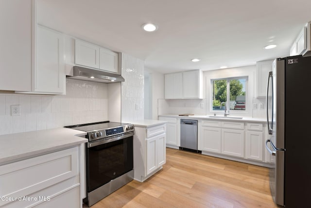 15116 E 4th Ave, Veradale, WA 99037 - kitchen featuring stainless steel appliances, under cabinet range hood, backsplash, white cabinetry, and recessed lighting