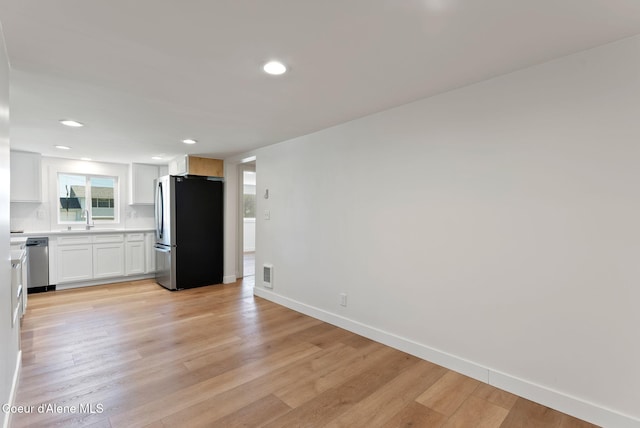 15116 E 4th Ave, Veradale, WA 99037 - kitchen featuring appliances with stainless steel finishes, light wood-type flooring, white cabinetry, light countertops, and recessed lighting