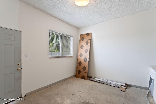 15116 E 4th Ave, Veradale, WA 99037 - empty room featuring unfinished concrete floors and a textured ceiling