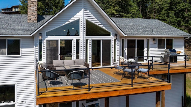 1273 S Grouse Meadow Dr, Coeur Dalene, ID 83814 - rear view of house featuring roof with shingles, a chimney, a wooden deck, and outdoor dining area