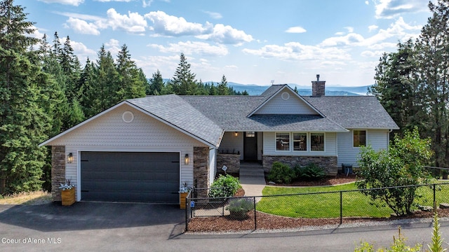 1273 S Grouse Meadow Dr, Coeur Dalene, ID 83814 - view of front of house featuring stone siding, a chimney, a fenced front yard, and driveway