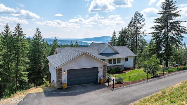 1273 S Grouse Meadow Dr, Coeur Dalene, ID 83814 - view of front facade with asphalt driveway, an attached garage, a mountain view, stone siding, and a chimney