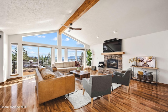1273 S Grouse Meadow Dr, Coeur Dalene, ID 83814 - living room with hardwood / wood-style flooring, a stone fireplace, a ceiling fan, and a textured ceiling