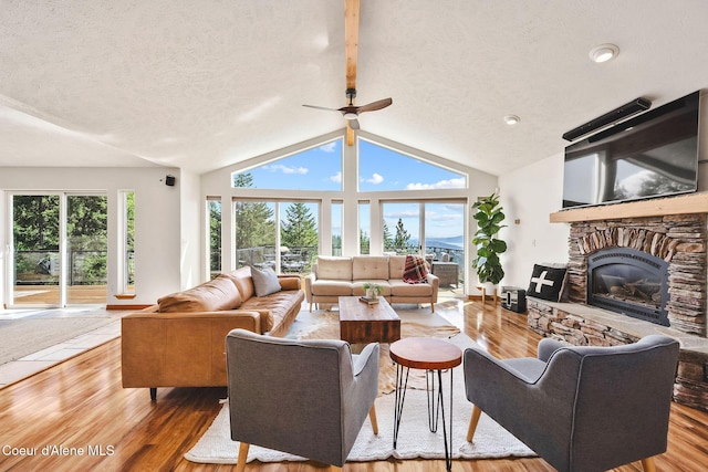 1273 S Grouse Meadow Dr, Coeur Dalene, ID 83814 - living room with wood finished floors, a fireplace, a textured ceiling, and ceiling fan