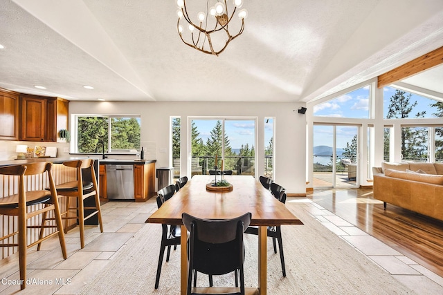 1273 S Grouse Meadow Dr, Coeur Dalene, ID 83814 - dining space with lofted ceiling, a textured ceiling, recessed lighting, stone tile flooring, and a chandelier
