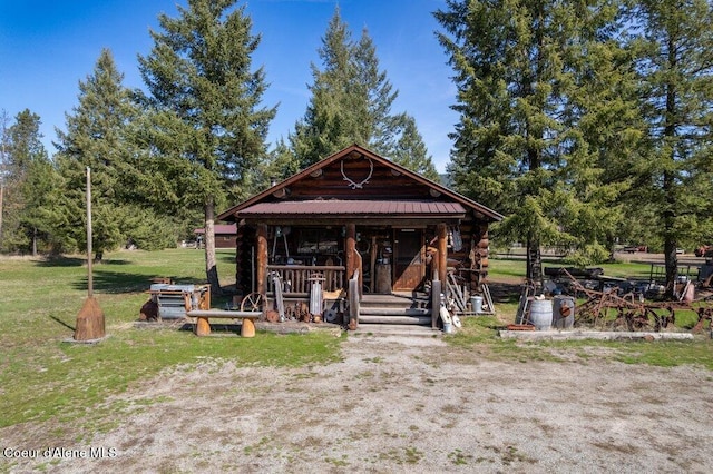 72 Hank Allen Way, Blanchard, ID 83804 - cabin with log exterior, a metal roof, and a front lawn