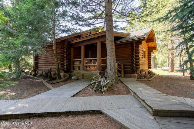 72 Hank Allen Way, Blanchard, ID 83804 - view of front facade featuring log exterior and a wooden deck