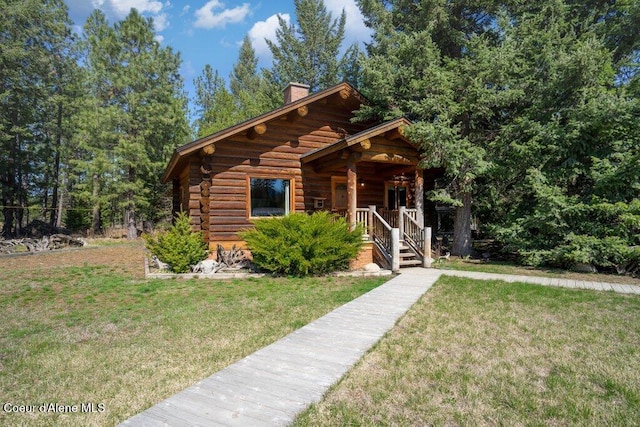 72 Hank Allen Way, Blanchard, ID 83804 - log home featuring log exterior, a chimney, a porch, and a front yard