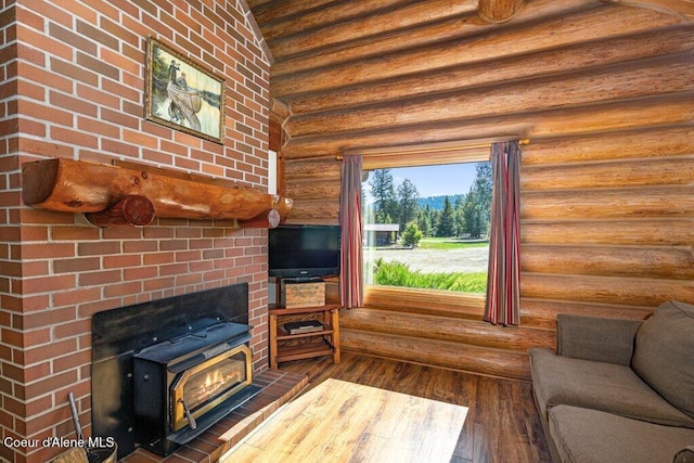72 Hank Allen Way, Blanchard, ID 83804 - living room featuring log walls, hardwood / wood-style floors, and a wood stove