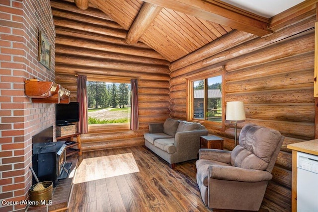 72 Hank Allen Way, Blanchard, ID 83804 - living room with a wood stove, plenty of natural light, wooden ceiling, dark wood-type flooring, and rustic walls