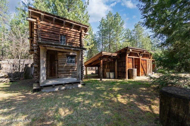 72 Hank Allen Way, Blanchard, ID 83804 - rear view of house with an outbuilding and a yard