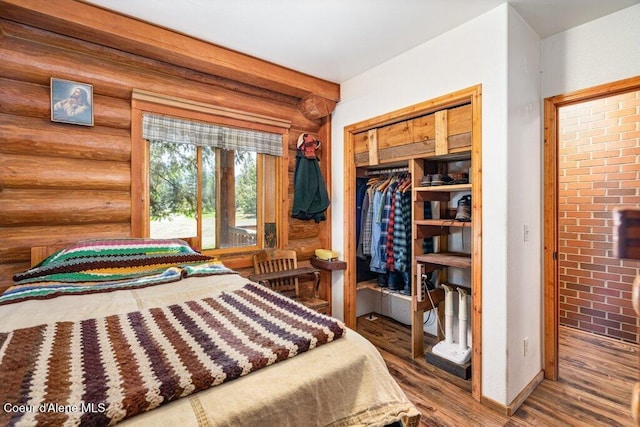 72 Hank Allen Way, Blanchard, ID 83804 - bedroom with log walls, wood finished floors, and a closet