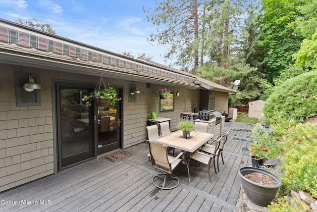 3011 E Fernan Ct, Coeur Dalene, ID 83814 - deck with outdoor dining area and a storage shed