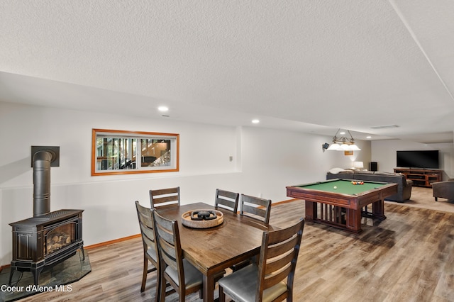 515 S Idaho St, Post Falls, ID 83854 - dining space featuring wood finished floors, a wood stove, a textured ceiling, recessed lighting, and billiards