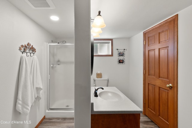 515 S Idaho St, Post Falls, ID 83854 - bathroom with a shower stall, wood finished floors, and vanity