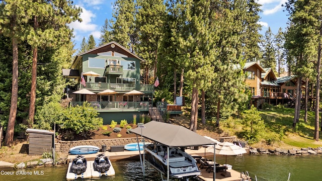 515 S Idaho St, Post Falls, ID 83854 - dock featuring a water view, a balcony, boat lift, and view of wooded area
