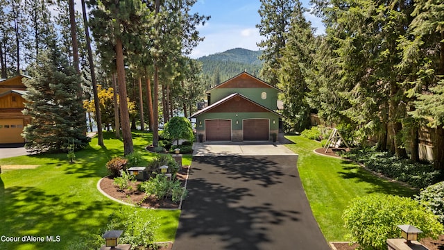 515 S Idaho St, Post Falls, ID 83854 - view of front facade featuring a mountain view, a garage, driveway, a front yard, and stone siding