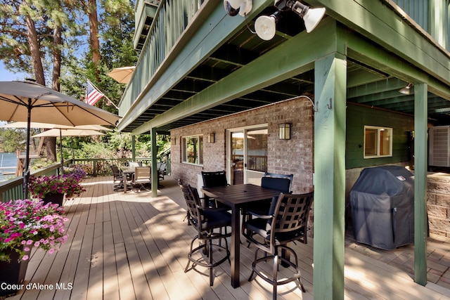 515 S Idaho St, Post Falls, ID 83854 - wooden deck with outdoor dining area and area for grilling