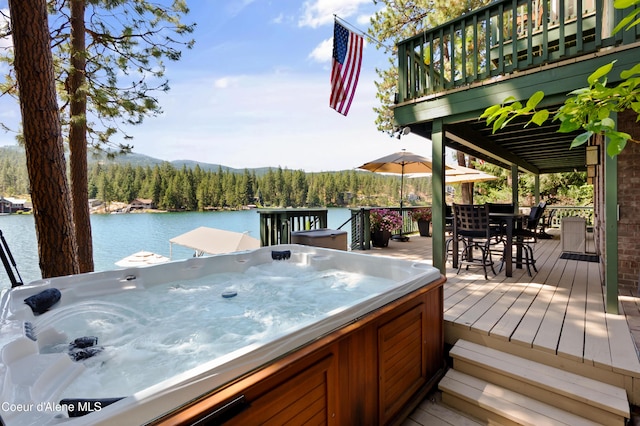 515 S Idaho St, Post Falls, ID 83854 - deck with a water and mountain view, a hot tub, outdoor dining space, and area for grilling
