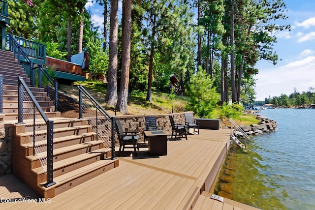 515 S Idaho St, Post Falls, ID 83854 - wooden deck with stairs, a water view, and view of scattered trees