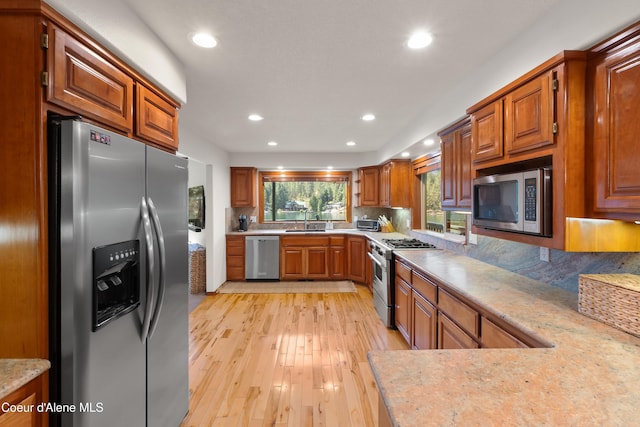 515 S Idaho St, Post Falls, ID 83854 - kitchen with stainless steel appliances, backsplash, brown cabinets, recessed lighting, and light wood-style flooring