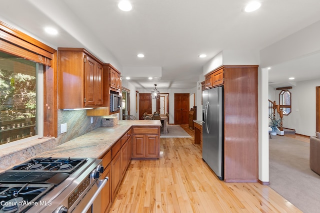515 S Idaho St, Post Falls, ID 83854 - kitchen with appliances with stainless steel finishes, a peninsula, recessed lighting, light wood-style flooring, and backsplash