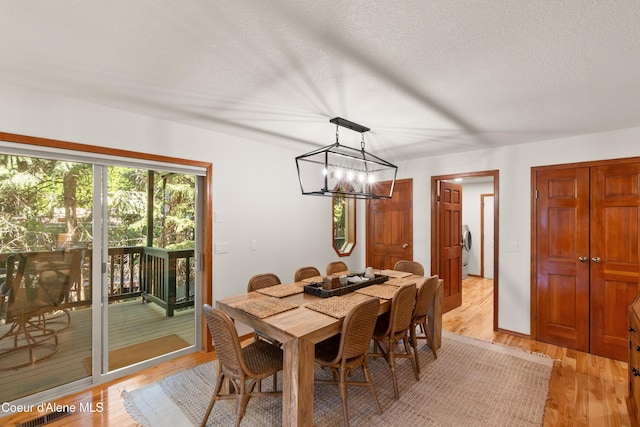 515 S Idaho St, Post Falls, ID 83854 - dining area featuring a chandelier, light wood-type flooring, and a textured ceiling