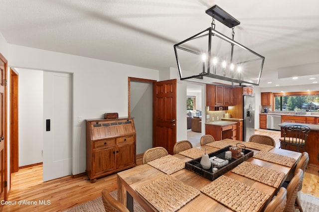515 S Idaho St, Post Falls, ID 83854 - dining area with light wood-style flooring, a chandelier, and recessed lighting