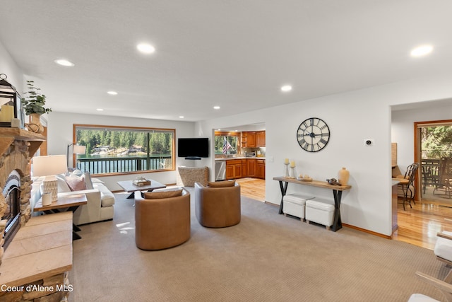 515 S Idaho St, Post Falls, ID 83854 - living area featuring recessed lighting, a fireplace, light carpet, and light wood finished floors