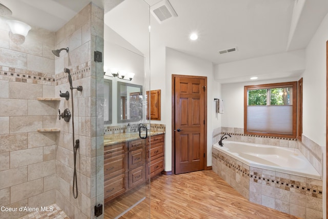 515 S Idaho St, Post Falls, ID 83854 - bathroom with vanity, tiled shower, wood finished floors, and a bath