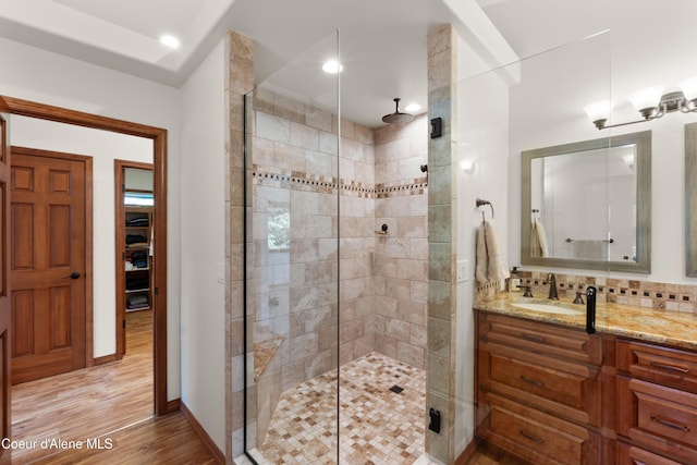 515 S Idaho St, Post Falls, ID 83854 - bathroom with a shower stall, vanity, wood finished floors, tasteful backsplash, and recessed lighting