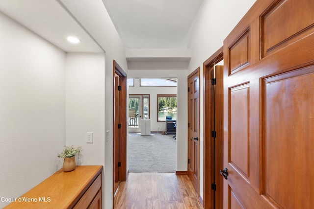 515 S Idaho St, Post Falls, ID 83854 - hallway featuring light wood-type flooring and light colored carpet