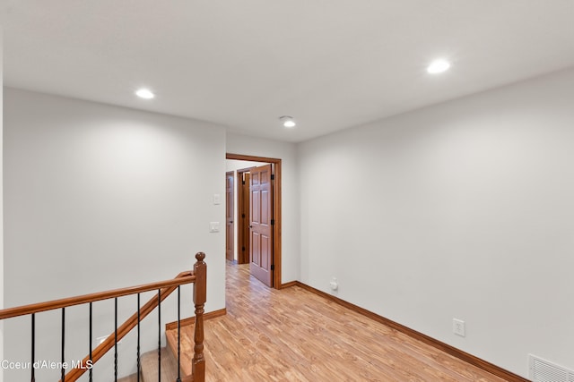 515 S Idaho St, Post Falls, ID 83854 - hallway with light wood finished floors, recessed lighting, and an upstairs landing