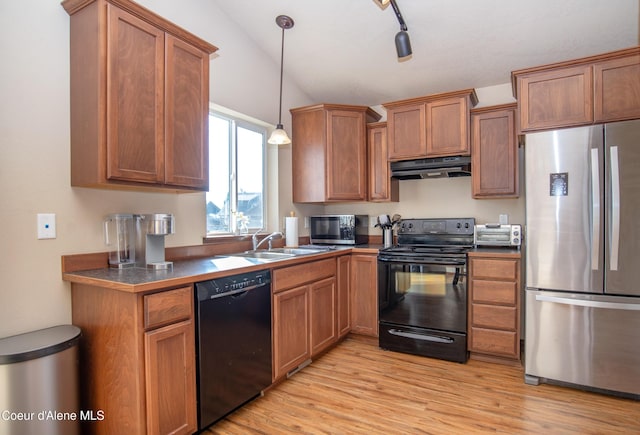 7938 W Kayak Ct Unit 104, Rathdrum, ID 83858 - kitchen featuring black appliances, ventilation hood, dark countertops, and brown cabinets