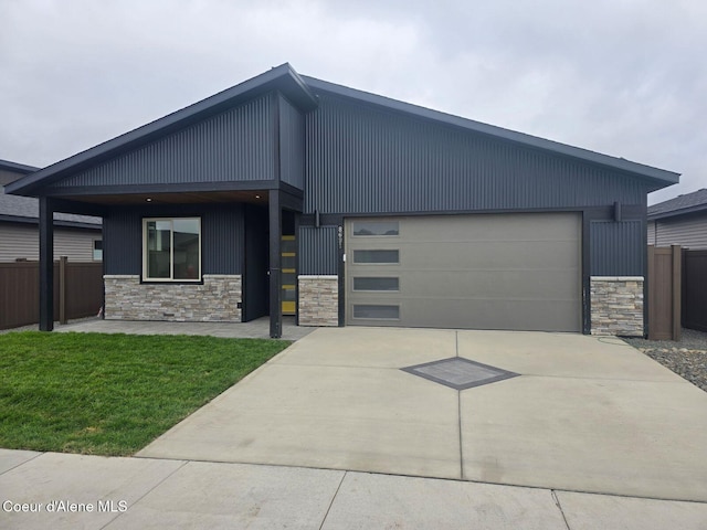 13936 N Rainier Loop, Rathdrum, ID 83858 - modern home with stone siding, concrete driveway, and an attached garage