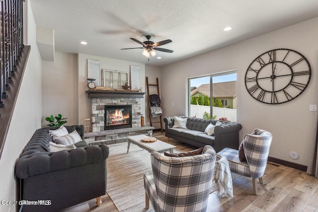 1546 N Tatum Dr, Post Falls, ID 83854 - living room featuring a ceiling fan, light wood-style floors, stairs, a stone fireplace, and recessed lighting