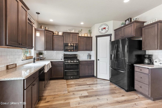1546 N Tatum Dr, Post Falls, ID 83854 - kitchen with range with two ovens, fridge with ice dispenser, backsplash, dishwashing machine, and light wood-type flooring