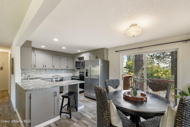 1024 W Mill Ave, Coeur Dalene, ID 83814 - dining room featuring a textured ceiling, light wood-style flooring, and recessed lighting