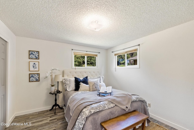 1024 W Mill Ave, Coeur Dalene, ID 83814 - bedroom with wood finished floors and a textured ceiling