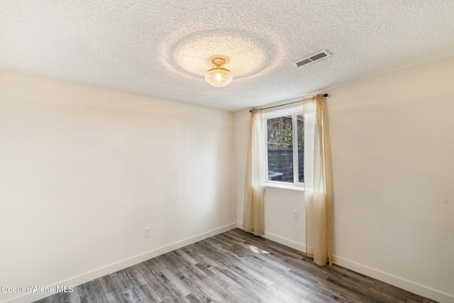 1024 W Mill Ave, Coeur Dalene, ID 83814 - empty room with wood finished floors and a textured ceiling