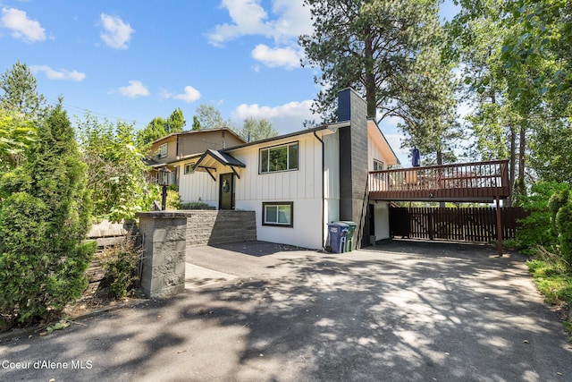 1024 W Mill Ave, Coeur Dalene, ID 83814 - view of front of property with a chimney, a deck, and asphalt driveway