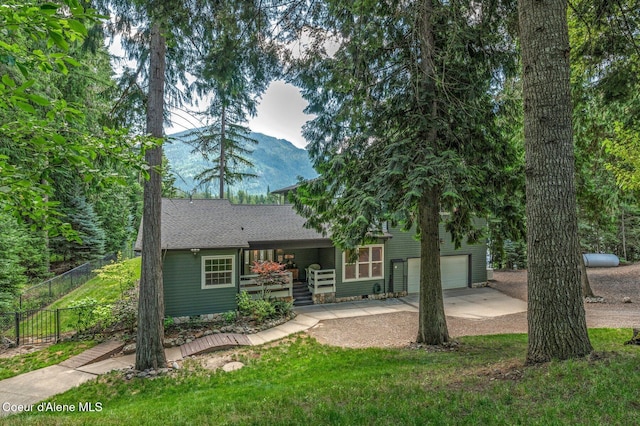 512 River Dr, Clark Fork, ID 83811 - view of front facade with concrete driveway, a garage, a porch, and a shingled roof