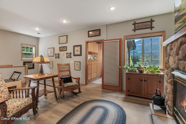 512 River Dr, Clark Fork, ID 83811 - living area featuring a stone fireplace, light wood-style floors, and recessed lighting