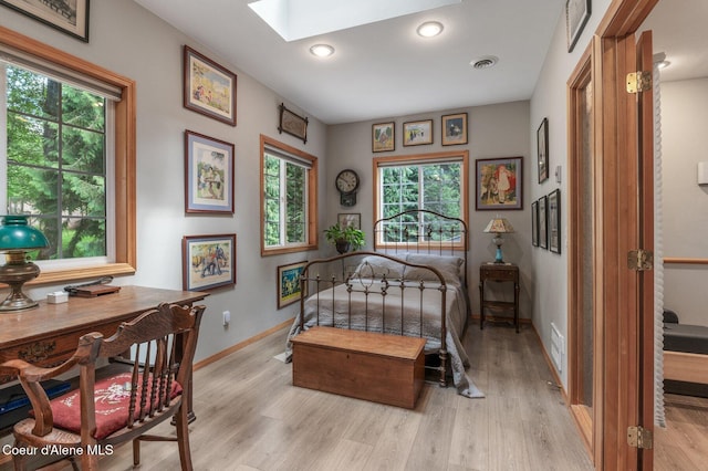 512 River Dr, Clark Fork, ID 83811 - bedroom with a skylight, light wood-style floors, and recessed lighting