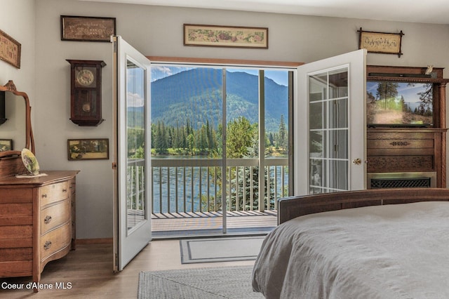 512 River Dr, Clark Fork, ID 83811 - bedroom with access to outside, a mountain view, and wood finished floors