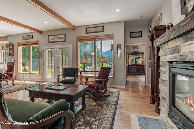 512 River Dr, Clark Fork, ID 83811 - living room with a fireplace, beamed ceiling, light wood-style floors, and recessed lighting
