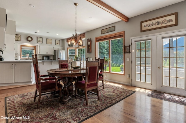512 River Dr, Clark Fork, ID 83811 - dining area with light wood finished floors, a chandelier, recessed lighting, beam ceiling, and french doors